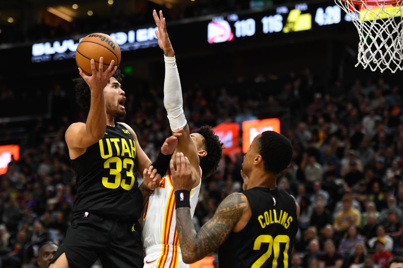 SALT LAKE CITY, UTAH - MARCH 15: Johnny Juzang #33 of the Utah Jazz shoots over Jalen Johnson #1 of the Atlanta Hawks during the second half of a game at Delta Center on March 15, 2024 in Salt Lake City, Utah.  NOTE TO USER: User expressly acknowledges and agrees that, by downloading and or using this photograph, User is consenting to the terms and conditions of the Getty Images License Agreement.  (Photo by Alex Goodlett/Getty Images)