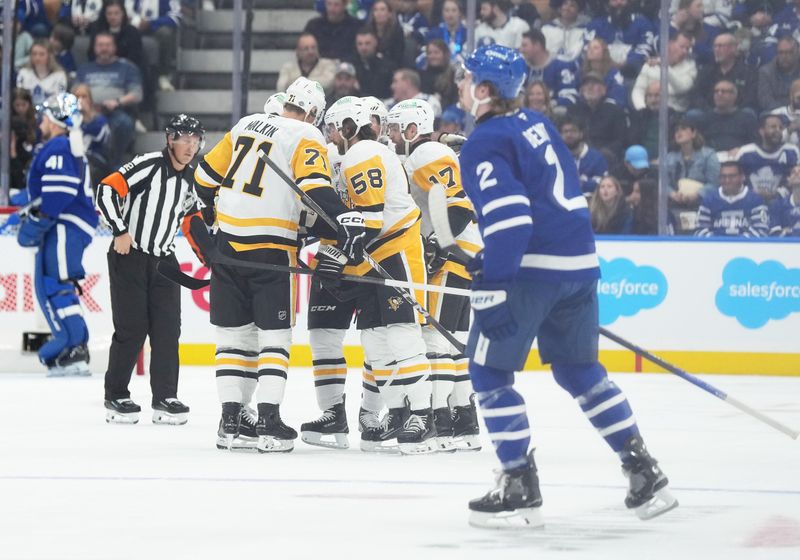 Oct 12, 2024; Toronto, Ontario, CAN; Pittsburgh Penguins defenseman Kris Letang (58) scores a goal and celebrates with center Evgeni Malkin (71) against the Toronto Maple Leafs during the first period at Scotiabank Arena. Mandatory Credit: Nick Turchiaro-Imagn Images