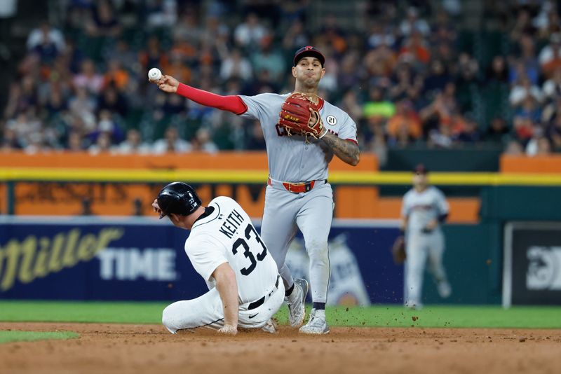 Sep 16, 2025; Detroit, Michigan, USA;  Cleveland Guardians shortstop Brayan Rocchio (4) makes a throw to first as Detroit Tigers second base Colt Keith (33) always into second in the sixth inning at Comerica Park. Mandatory Credit: Rick Osentoski-Imagn Images