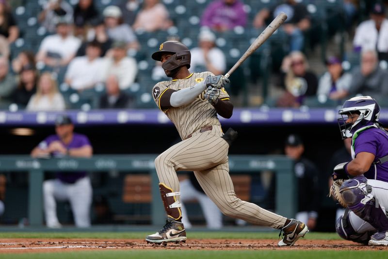 Apr 22, 2024; Denver, Colorado, USA; San Diego Padres designated hitter Jurickson Profar (10) hits an RBI single in the third inning against the Colorado Rockies at Coors Field. Mandatory Credit: Isaiah J. Downing-USA TODAY Sports