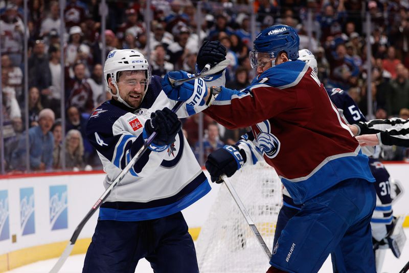 Apr 26, 2024; Denver, Colorado, USA; Winnipeg Jets defenseman Neal Pionk (4) and Colorado Avalanche right wing Valeri Nichushkin (13) push each other in the second period in game three of the first round of the 2024 Stanley Cup Playoffs at Ball Arena. Mandatory Credit: Isaiah J. Downing-USA TODAY Sports