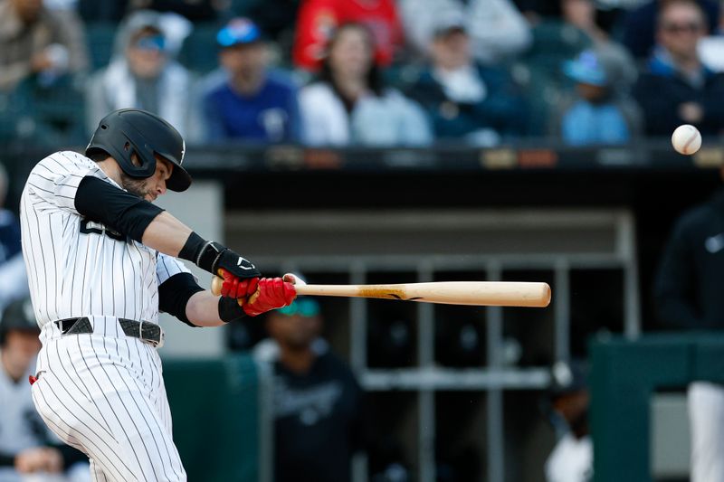 May 24, 2025; Chicago, Illinois, USA; Chicago White Sox designated hitter Andrew Benintendi (23) hits a two-run double against the Texas Rangers during the sixth inning at Rate Field. Mandatory Credit: Kamil Krzaczynski-Imagn Images