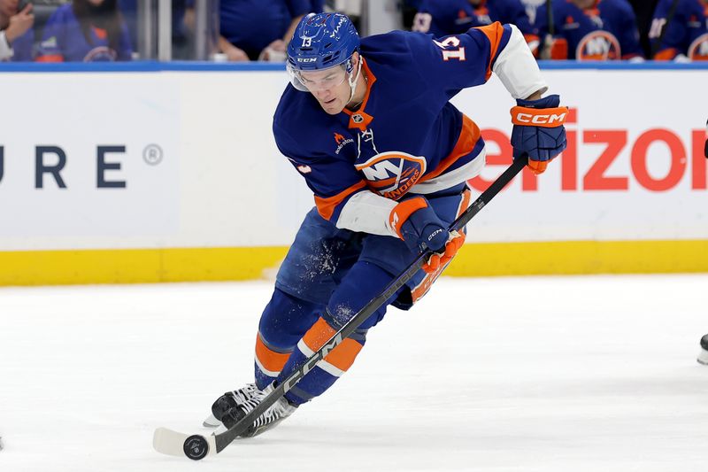 Jan 24, 2025; Elmont, New York, USA; New York Islanders center Mathew Barzal (13) skates with the puck against the Philadelphia Flyers during the second period at UBS Arena. Mandatory Credit: Brad Penner-Imagn Images