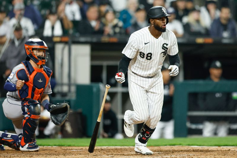 May 13, 2023; Chicago, Illinois, USA; Chicago White Sox center fielder Luis Robert Jr. (88) watches his RBI-single against the Houston Astros during the eighth inning at Guaranteed Rate Field. Mandatory Credit: Kamil Krzaczynski-USA TODAY Sports