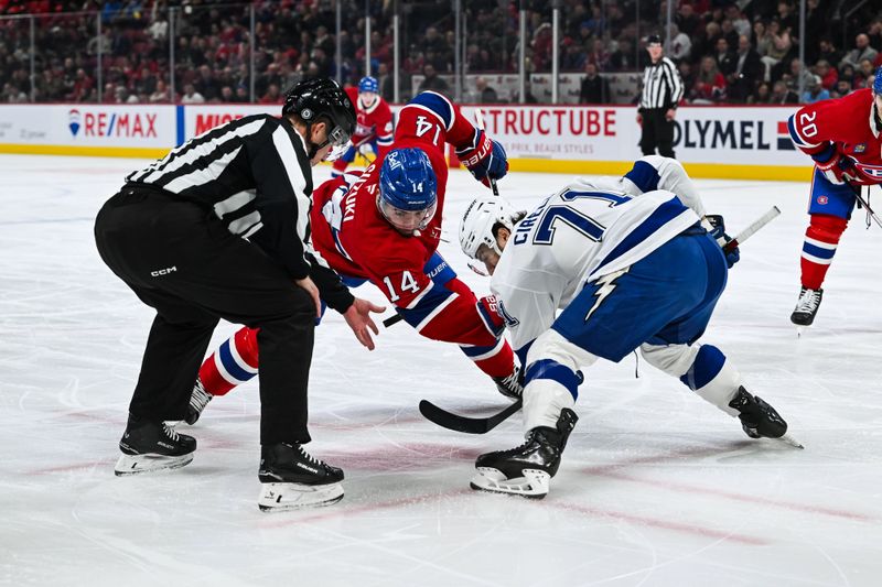 Jan 21, 2025; Montreal, Quebec, CAN; NHL linesman Julien Fournier (56) drops the puck for a face-off between Montreal Canadiens center Nick Suzuki (14) and Tampa Bay Lightning center Anthony Cirelli (71) during the first period at Bell Centre. Mandatory Credit: David Kirouac-Imagn Images