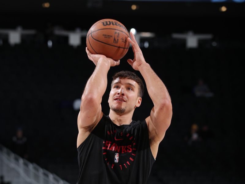 MILWAUKEE, WI - DECEMBER 4:  Bogdan Bogdanovic #13 of the Atlanta Hawks warms up before the game against the Milwaukee Bucks during a regular season game on December 4, 2024 at Fiserv Forum Center in Milwaukee, Wisconsin. NOTE TO USER: User expressly acknowledges and agrees that, by downloading and or using this Photograph, user is consenting to the terms and conditions of the Getty Images License Agreement. Mandatory Copyright Notice: Copyright 2024 NBAE (Photo by Gary Dineen/NBAE via Getty Images).