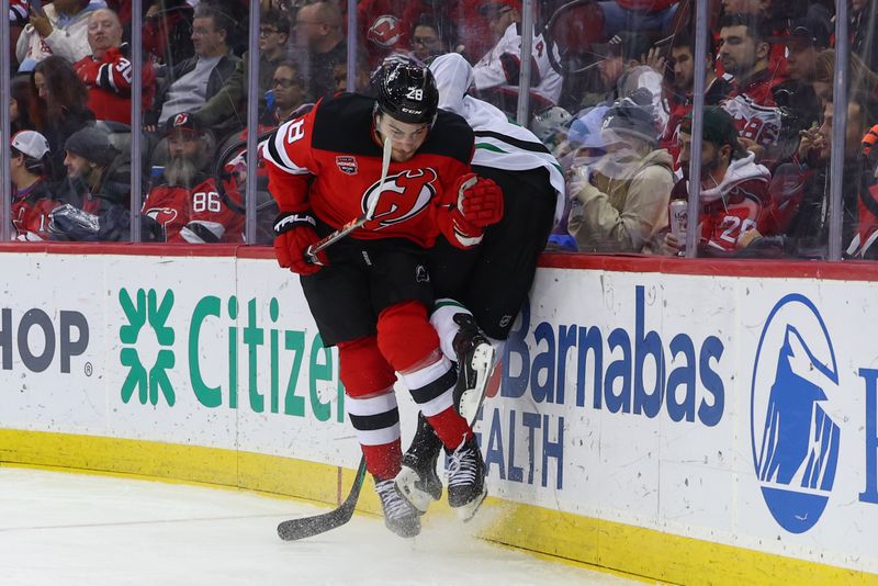 Jan 20, 2024; Newark, New Jersey, USA; New Jersey Devils right wing Timo Meier (28) hits Dallas Stars center Craig Smith (15) during the third period at Prudential Center. Mandatory Credit: Ed Mulholland-USA TODAY Sports