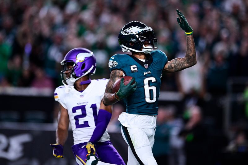 Philadelphia Eagles wide receiver DeVonta Smith (6) celebrates his touchdown in front of Minnesota Vikings cornerback Akayleb Evans (21) during the second half of an NFL football game Thursday, Sept. 14, 2023, in Philadelphia. (AP Photo/Derik Hamilton)