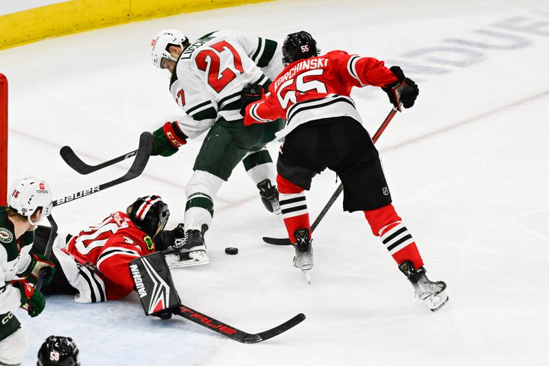 Apr 7, 2024; Chicago, Illinois, USA;  Chicago Blackhawks goaltender Arvid Soderblom (40) and defenseman Kevin Korchinski (55) chase the puck with Minnesota Wild center Jacob Lucchini (27)  during the second period at United Center. Mandatory Credit: Matt Marton-USA TODAY Sports