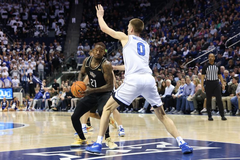 Feb 13, 2024; Provo, Utah, USA; Central Florida Knights forward C.J. Walker (21) goes to the basket against Brigham Young Cougars forward Noah Waterman (0) during the first half at Marriott Center. Mandatory Credit: Rob Gray-USA TODAY Sports