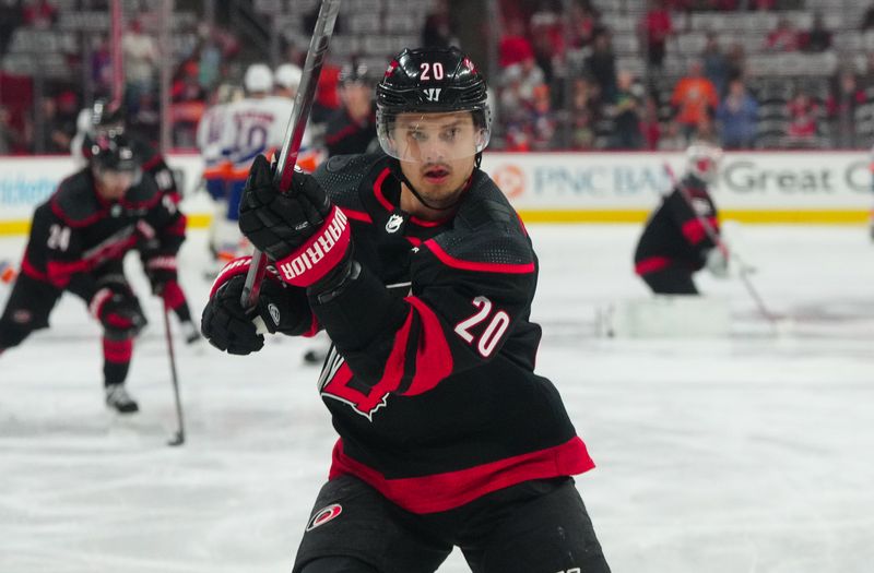 Apr 30, 2024; Raleigh, North Carolina, USA; Carolina Hurricanes center Sebastian Aho (20) takes a shot during the warmups before the game against the New York Islanders in game five of the first round of the 2024 Stanley Cup Playoffs at PNC Arena. Mandatory Credit: James Guillory-USA TODAY Sports