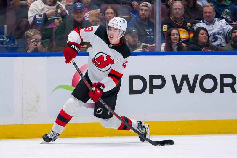 Oct 30, 2024; Vancouver, British Columbia, CAN; New Jersey Devils defenseman Luke Hughes (43) shoots against the Vancouver Canucks during the first period at Rogers Arena. Mandatory Credit: Bob Frid-Imagn Images