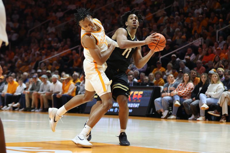Feb 15, 2025; Knoxville, Tennessee, USA; Vanderbilt Commodores guard AJ Hoggard (11) moves the ball against Tennessee Volunteers guard Jordan Gainey (11) during the first half at Thompson-Boling Arena at Food City Center. Mandatory Credit: Randy Sartin-Imagn Images