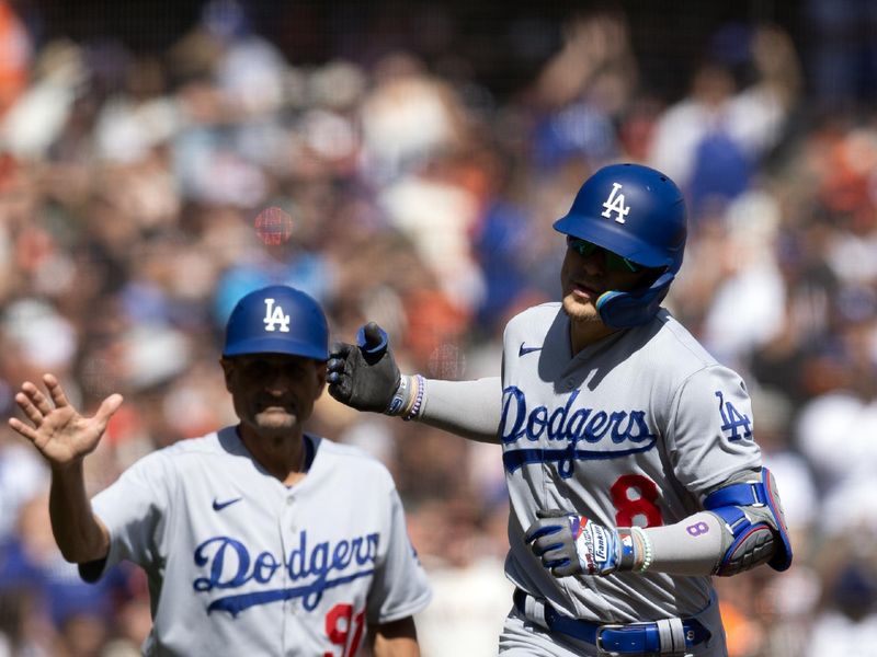 Oct 1, 2023; San Francisco, California, USA; Los Angeles Dodgers shortstop Enrique Hern  ndez (8) gets a congratulatory handshake from third base coach Dino Ebel (91) after hitting a three-run home run against the San Francisco Giants during the sixth inning at Oracle Park. Mandatory Credit: D. Ross Cameron-USA TODAY Sports