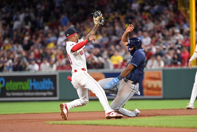 May 14, 2024; Boston, Massachusetts, USA; Tampa Bay Rays third baseman Amed Rosario (10) is tagged out by Boston Red Sox shortstop Ceddanne Rafaela (43) trying to steal second base during the ninth inning at Fenway Park. Mandatory Credit: Eric Canha-USA TODAY Sports