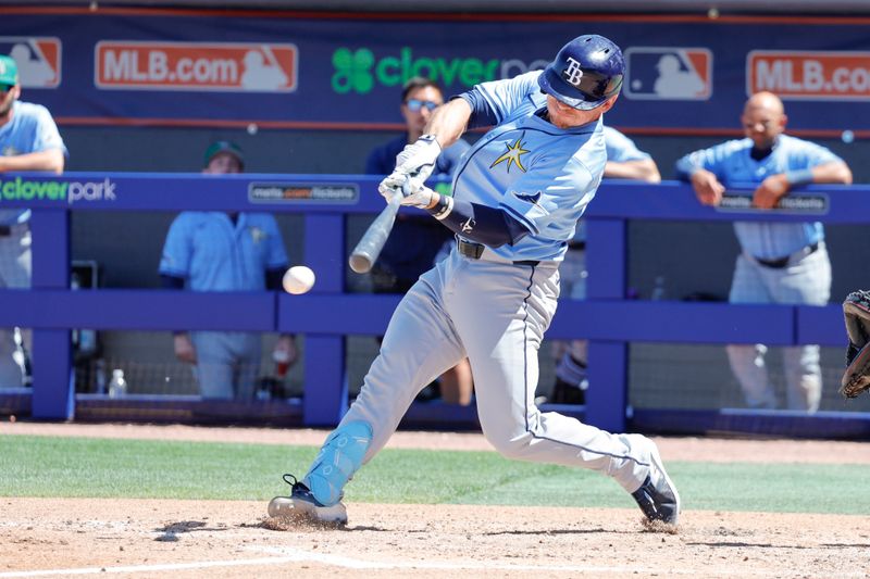 Mar 17, 2025; Port St. Lucie, Florida, USA;  Tampa Bay Rays catcher Ben Rortvedt (30) hits the ball scoring the runner from third during the sixth inning against the New York Mets at Clover Park. Mandatory Credit: Reinhold Matay-Imagn Images 
