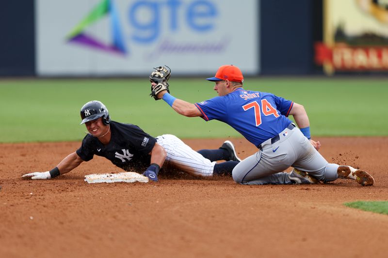 Mar 22, 2024; Tampa, Florida, USA;  New York Yankees shortstop Anthony Volpe (11) steals second base from New York Mets second baseman Zack Short (74) in the fourth inning at George M. Steinbrenner Field. Mandatory Credit: Nathan Ray Seebeck-USA TODAY Sports