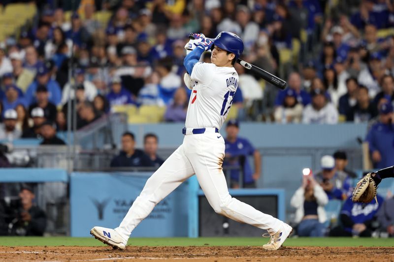 Jun 1, 2024; Los Angeles, California, USA;  Los Angeles Dodgers designated hitter Shohei Ohtani (17) hits a single during the seventh inning against the Colorado Rockies at Dodger Stadium. Mandatory Credit: Kiyoshi Mio-USA TODAY Sports