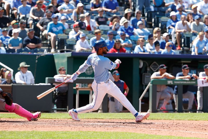 May 11, 2025; Kansas City, Missouri, USA; Kansas City Royals third base Maikel Garcia (11) hits the ball at Kauffman Stadium. Mandatory Credit: Gary Rohman-Imagn Images
