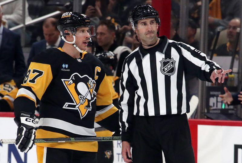 Nov 2, 2024; Pittsburgh, Pennsylvania, USA;  Pittsburgh Penguins center Sidney Crosby (87) talks with linesman Andrew Smith (51) against the Montreal Canadiens during the third period at PPG Paints Arena. Mandatory Credit: Charles LeClaire-Imagn Images