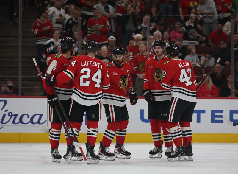 Oct 3, 2025; Chicago, Illinois, USA;  The Chicago Blackhawks celebrate a first period goal against the Minnesota Wild at United Center. Mandatory Credit: Talia Sprague-Imagn Images