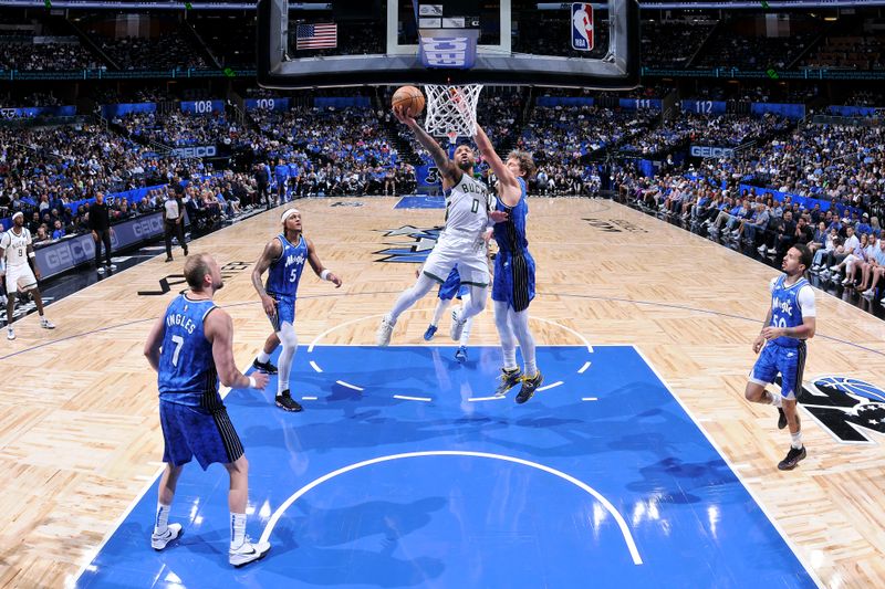 ORLANDO, FL - APRIL 14: Damian Lillard #0 of the Milwaukee Bucks drives to the basket during the game against the Orlando Magic on April 14, 2024 at Kia Center in Orlando, Florida. NOTE TO USER: User expressly acknowledges and agrees that, by downloading and or using this photograph, User is consenting to the terms and conditions of the Getty Images License Agreement. Mandatory Copyright Notice: Copyright 2024 NBAE (Photo by Fernando Medina/NBAE via Getty Images)