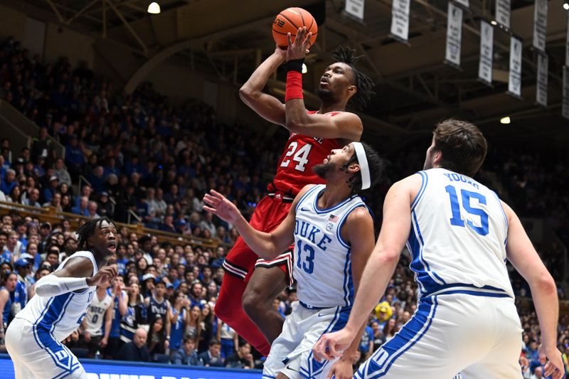 Feb 20, 2023; Durham, North Carolina, USA; Louisville Cardinals forward Jae'Lyn Withers (24) shoots over Duke Blue Devils guard Jacob Grandison (13) during the first half at Cameron Indoor Stadium. Mandatory Credit: Rob Kinnan-USA TODAY Sports