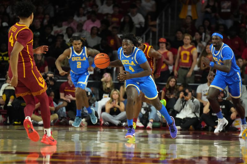 Jan 27, 2024; Los Angeles, California, USA; UCLA Bruins guard Will McClendon (4) dribbles the ball against the Southern California Trojans in the first half at Galen Center. Mandatory Credit: Kirby Lee-USA TODAY Sports