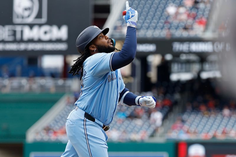 May 5, 2024; Washington, District of Columbia, USA; Toronto Blue Jays first baseman Vladimir Guerrero Jr. (27) celebrates while rounding the bases after hitting a grand slam against the Washington Nationals during the second inning at Nationals Park. Mandatory Credit: Geoff Burke-USA TODAY Sports