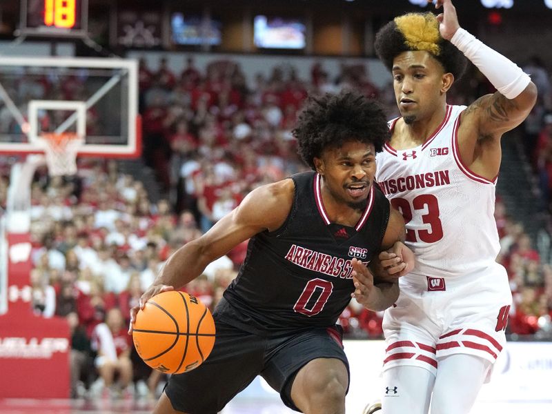 Nov 6, 2023; Madison, Wisconsin, USA;  Arkansas State Red Wolves guard Caleb Fields (0) drives to the basket under coverage by Wisconsin Badgers guard Chucky Hepburn (23) during the first half at the Kohl Center. Mandatory Credit: Kayla Wolf-USA TODAY Sports