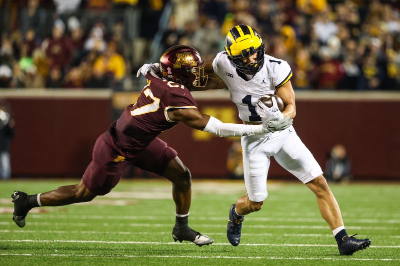 Oct 7, 2023; Minneapolis, Minnesota, USA; Michigan Wolverines wide receiver Roman Wilson (1) runs while Minnesota Golden Gophers defensive back Tyler Nubin (27) defends during the third quarter at Huntington Bank Stadium. Mandatory Credit: Matt Krohn-USA TODAY Sports