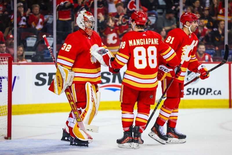 Apr 18, 2024; Calgary, Alberta, CAN; Calgary Flames goaltender Dustin Wolf (32) celebrate win with teammates after defeating San Jose Sharks at Scotiabank Saddledome. Mandatory Credit: Sergei Belski-USA TODAY Sports