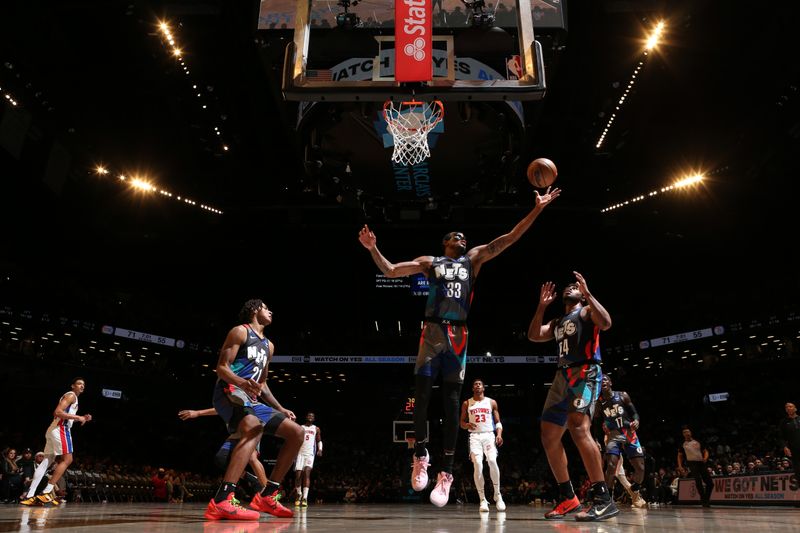 BROOKLYN, NY - APRIL 6: Nicolas Claxton #33 of the Brooklyn Nets grabs a rebound during the game against the Detroit Pistons on April 6, 2024 at Barclays Center in Brooklyn, New York. NOTE TO USER: User expressly acknowledges and agrees that, by downloading and or using this Photograph, user is consenting to the terms and conditions of the Getty Images License Agreement. Mandatory Copyright Notice: Copyright 2024 NBAE (Photo by Nathaniel S. Butler/NBAE via Getty Images)