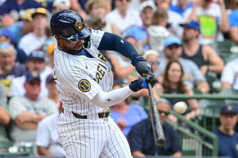 Jul 13, 2024; Milwaukee, Wisconsin, USA; Milwaukee Brewers second baseman Andruw Monasterio (14) hits a double to drive in a run against the Washington Nationals in the first inning at American Family Field. Mandatory Credit: Benny Sieu-USA TODAY Sports