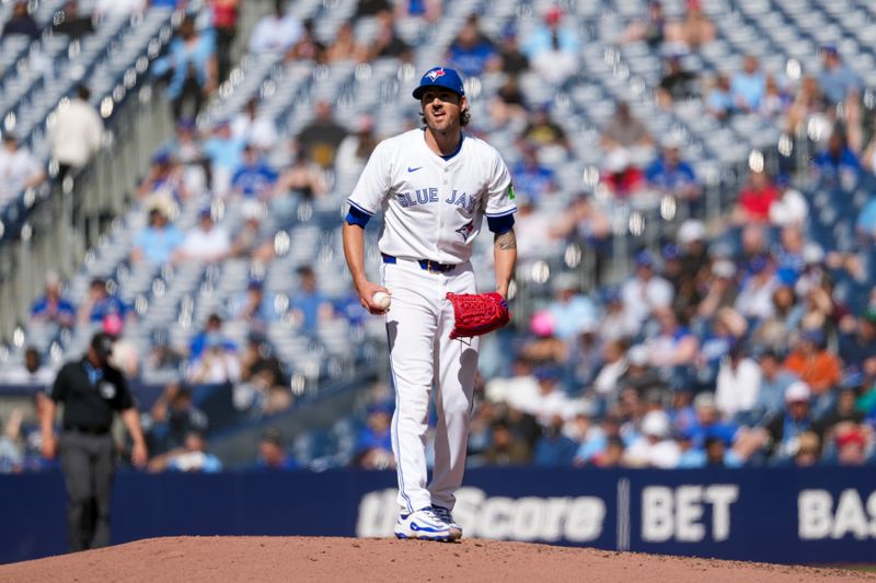 May 15, 2025; Toronto, Ontario, CAN; Toronto Blue Jays pitcher Kevin Gausman (34) reacts after giving up a home run to Josh Lowe (15) during the fifth inning at Rogers Centre. Mandatory Credit: Kevin Sousa-Imagn Images