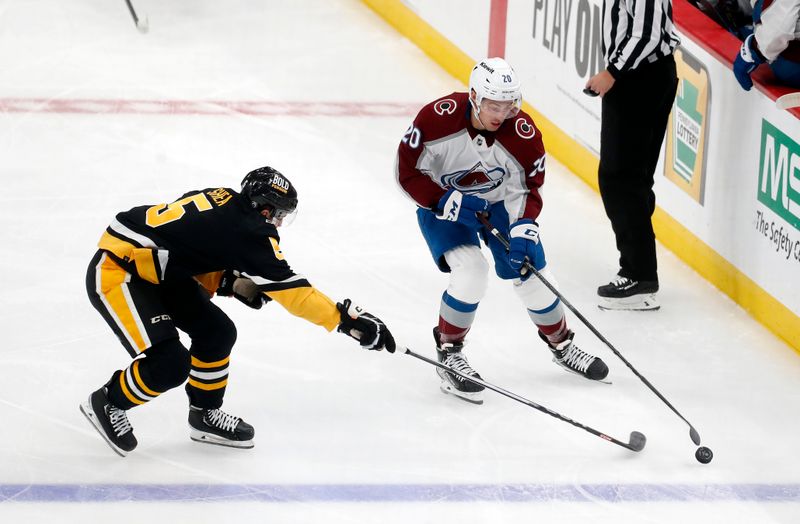 Oct 26, 2023; Pittsburgh, Pennsylvania, USA; Pittsburgh Penguins defenseman Ryan Shea (5) defends Colorado Avalanche center Ross Colton (20) during the second period at PPG Paints Arena. The Penguins shutout the Avalanche 4-0. Mandatory Credit: Charles LeClaire-USA TODAY Sports