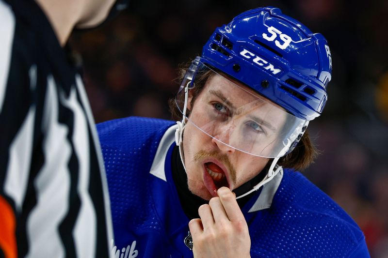 Mar 7, 2024; Boston, Massachusetts, USA; Toronto Maple Leafs left wing Tyler Bertuzzi (59) tries to show the referee that he is bleeding after being high sticked during the second period against the Boston Bruins at TD Garden. Mandatory Credit: Winslow Townson-USA TODAY Sports