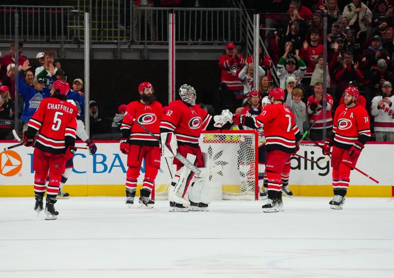 Nov 26, 2023; Raleigh, North Carolina, USA; Carolina Hurricanes players celebrate their victory against the Columbus Blue Jackets at PNC Arena. Mandatory Credit: James Guillory-USA TODAY Sports