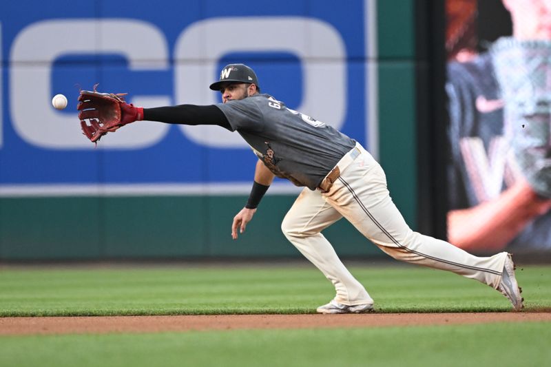 Jul 5, 2024; Washington, District of Columbia, USA; Washington Nationals second baseman Luis Garcia Jr. (2) stretches out for a line drive against the St. Louis Cardinals during the fourth inning at Nationals Park. Mandatory Credit: Rafael Suanes-USA TODAY Sports