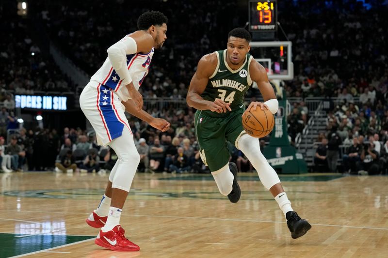 MILWAUKEE, WISCONSIN - OCTOBER 26: Giannis Antetokounmpo #34 of the Milwaukee Bucks dribbles the ball against Tobias Harris #12 of the Philadelphia 76ers in the first half at Fiserv Forum on October 26, 2023 in Milwaukee, Wisconsin. NOTE TO USER: User expressly acknowledges and agrees that, by downloading and or using this photograph, User is consenting to the terms and conditions of the Getty Images License Agreement. (Photo by Patrick McDermott/Getty Images)