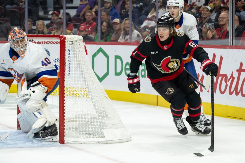 Nov 7, 2024; Ottawa, Ontario, CAN; Ottawa Senators right wing Adam Gaudette (81) skates behind New York Islanders goalie Semyon Varlamov (40) in the first period at the Canadian Tire Centre. Mandatory Credit: Marc DesRosiers-Imagn Images