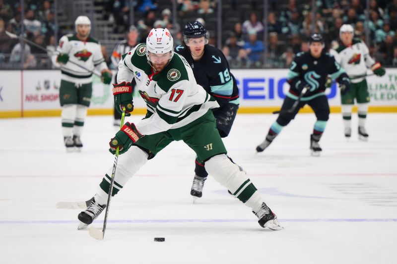 Dec 10, 2023; Seattle, Washington, USA; Minnesota Wild left wing Marcus Foligno (17) advances the puck against the Seattle Kraken during the third period at Climate Pledge Arena. Mandatory Credit: Steven Bisig-USA TODAY Sports