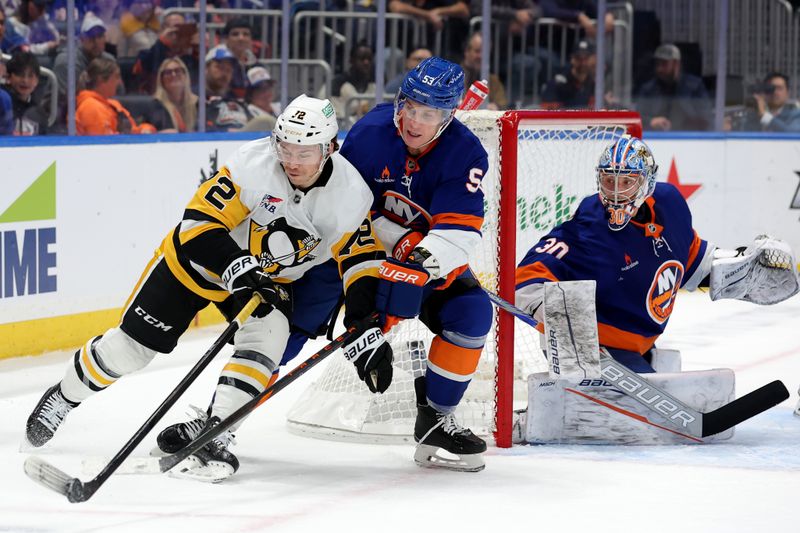 Nov 5, 2024; Elmont, New York, USA; Pittsburgh Penguins left wing Anthony Beauvillier (72) and New York Islanders center Casey Cizikas (53) fight for the puck in front of Islanders goaltender Ilya Sorokin (30) during the first period at UBS Arena. Mandatory Credit: Brad Penner-Imagn Images