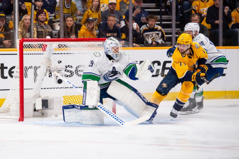 Apr 26, 2024; Nashville, Tennessee, USA; Vancouver Canucks goaltender Casey DeSmith (29) blocks the shot of Nashville Predators right wing Luke Evangelista (77) during the first period in game three of the first round of the 2024 Stanley Cup Playoffs at Bridgestone Arena. Mandatory Credit: Steve Roberts-USA TODAY Sports