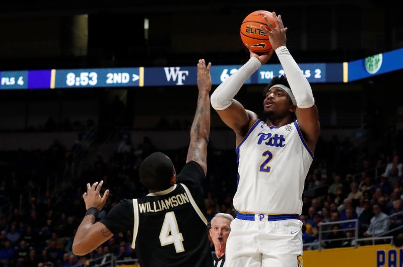 Jan 25, 2023; Pittsburgh, Pennsylvania, USA;  Pittsburgh Panthers forward Blake Hinson (2) shoots a three point basket against the Wake Forest Demon Deacons guard Daivien Williamson (4) during the second half at the Petersen Events Center. Pittsburgh won 81-79. Mandatory Credit: Charles LeClaire-USA TODAY Sports