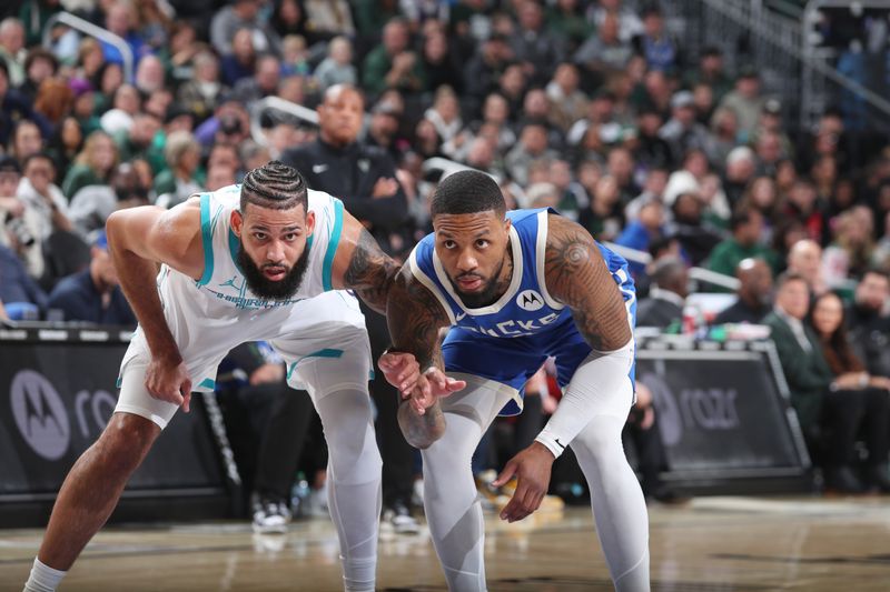 MILWAUKEE, WI - NOVEMBER 23: Cody Martin #11 of the Charlotte Hornets and Damian Lillard #0 of the Milwaukee Bucks look on during the Charlotte Hornets vs Milwaukee Bucks game on November 23, 2024 at the Fiserv Forum Center in Milwaukee, Wisconsin. NOTE TO USER: User expressly acknowledges and agrees that, by downloading and or using this Photograph, user is consenting to the terms and conditions of the Getty Images License Agreement. Mandatory Copyright Notice: Copyright 2024 NBAE (Photo by Gary Dineen/NBAE via Getty Images).