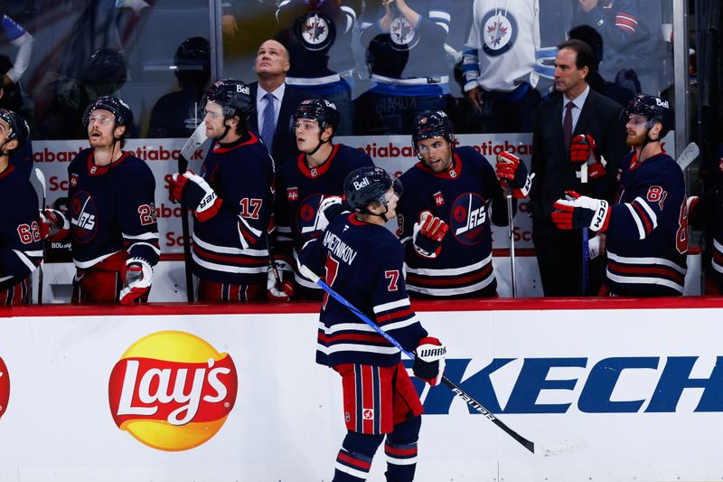 Oct 18, 2024; Winnipeg, Manitoba, CAN;  Winnipeg Jets forward Vladislav Namestnikov (7) is congratulated by his teammates on his goal against the San Jose Sharks during the third period at Canada Life Centre. Mandatory Credit: Terrence Lee-Imagn Images