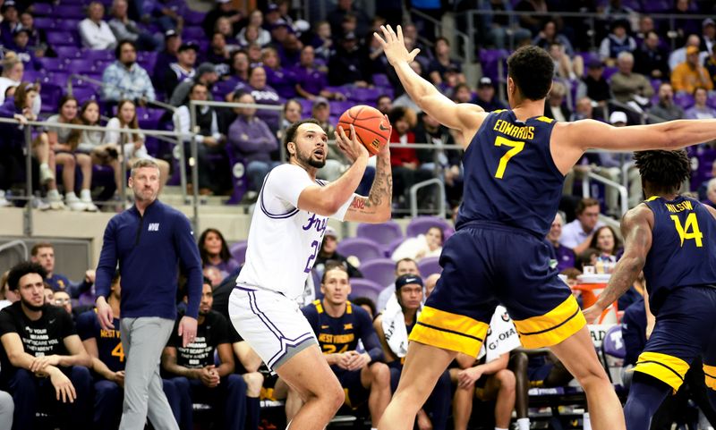 Feb 12, 2024; Fort Worth, Texas, USA;  TCU Horned Frogs forward JaKobe Coles (21) shoots over West Virginia Mountaineers center Jesse Edwards (7) during the first half at Ed and Rae Schollmaier Arena. Mandatory Credit: Kevin Jairaj-USA TODAY Sports