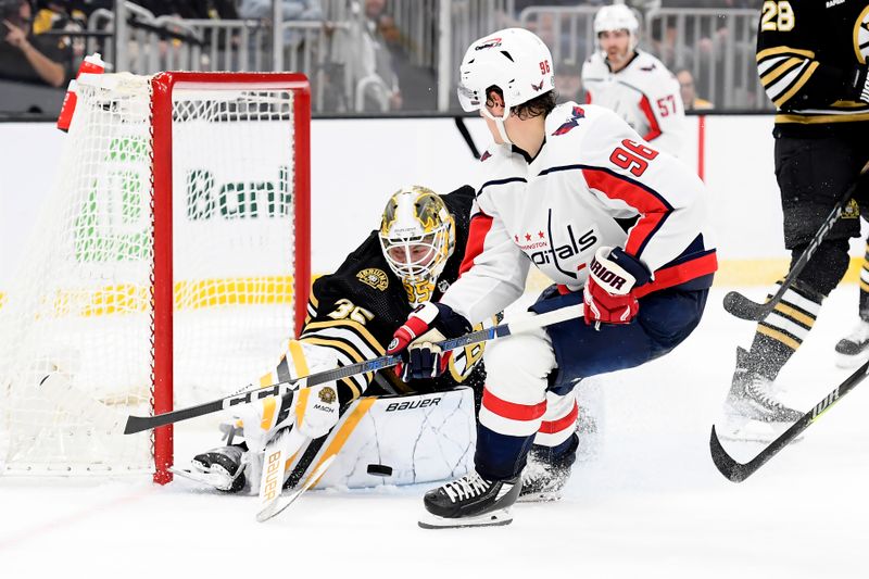 Oct 3, 2023; Boston, Massachusetts, USA; Boston Bruins goaltender Linus Ullmark (35) makes a save on Washington Capitals right wing Nicolas Aube-Kubel (96) during the second period at TD Garden. Mandatory Credit: Bob DeChiara-USA TODAY Sports