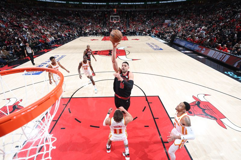 CHICAGO, IL - APRIL 17:  Nikola Vucevic #9 of the Chicago Bulls goes to the basket during the game against the Atlanta Hawks during the 2024 Play-In Tournament  on April 17, 2024 at United Center in Chicago, Illinois. NOTE TO USER: User expressly acknowledges and agrees that, by downloading and or using this photograph, User is consenting to the terms and conditions of the Getty Images License Agreement. Mandatory Copyright Notice: Copyright 2024 NBAE (Photo by Jeff Haynes/NBAE via Getty Images)